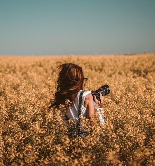 Red headed photographer in a field
